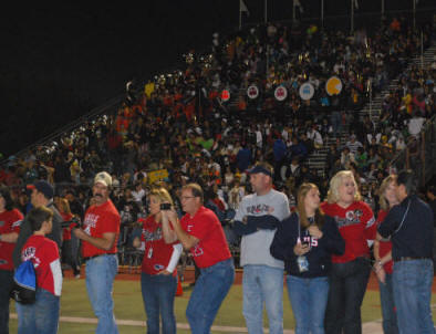 Senior football families form the run-through line for the players at Senior Night 2010.  (Photo  copyright 2010 Lauri McIntosh. All rights reserved. Used by permission.)