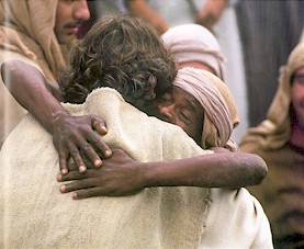 A paralytic man joyfully embraces Jesus after he is healed.  (Bruce Marchiano in "Matthew")